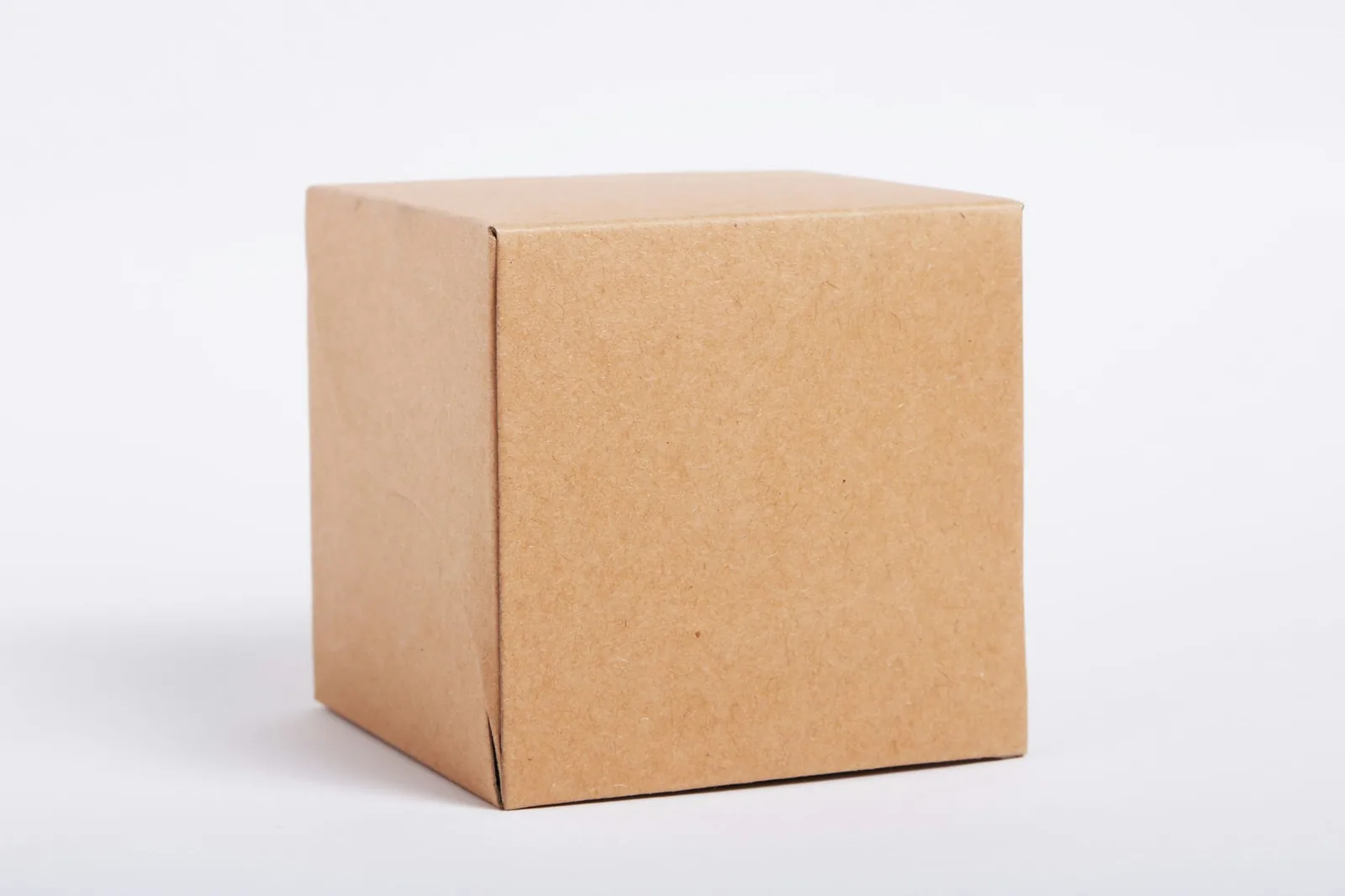 Plain cardboard shipping box on white, the discreet outer packaging to ask for when buying a watch as a gift