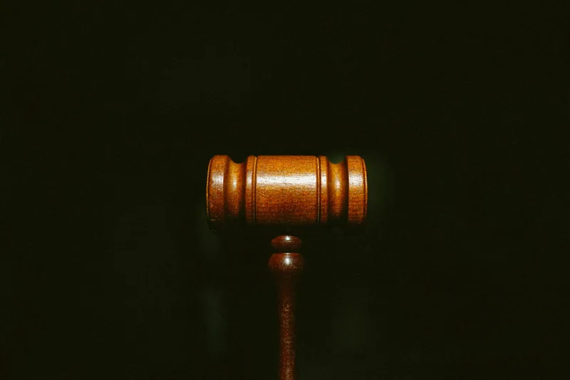 Wooden gavel lit against a black background
