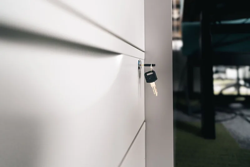 Key left in the lock of a white office drawer