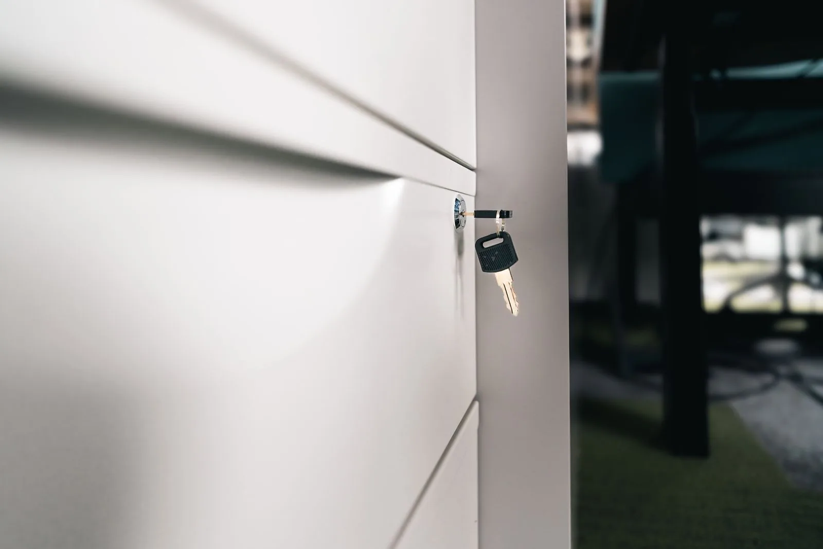 Key left in the lock of a white office drawer; security and storage conditions can decide a watch insurance claim in the UK