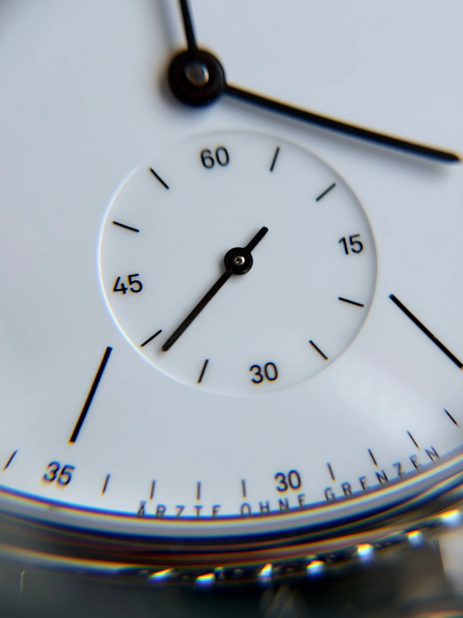 Minimalist dial with a subdial, black hands and baton markers; use a watch sizing guide to judge how a case will fit
