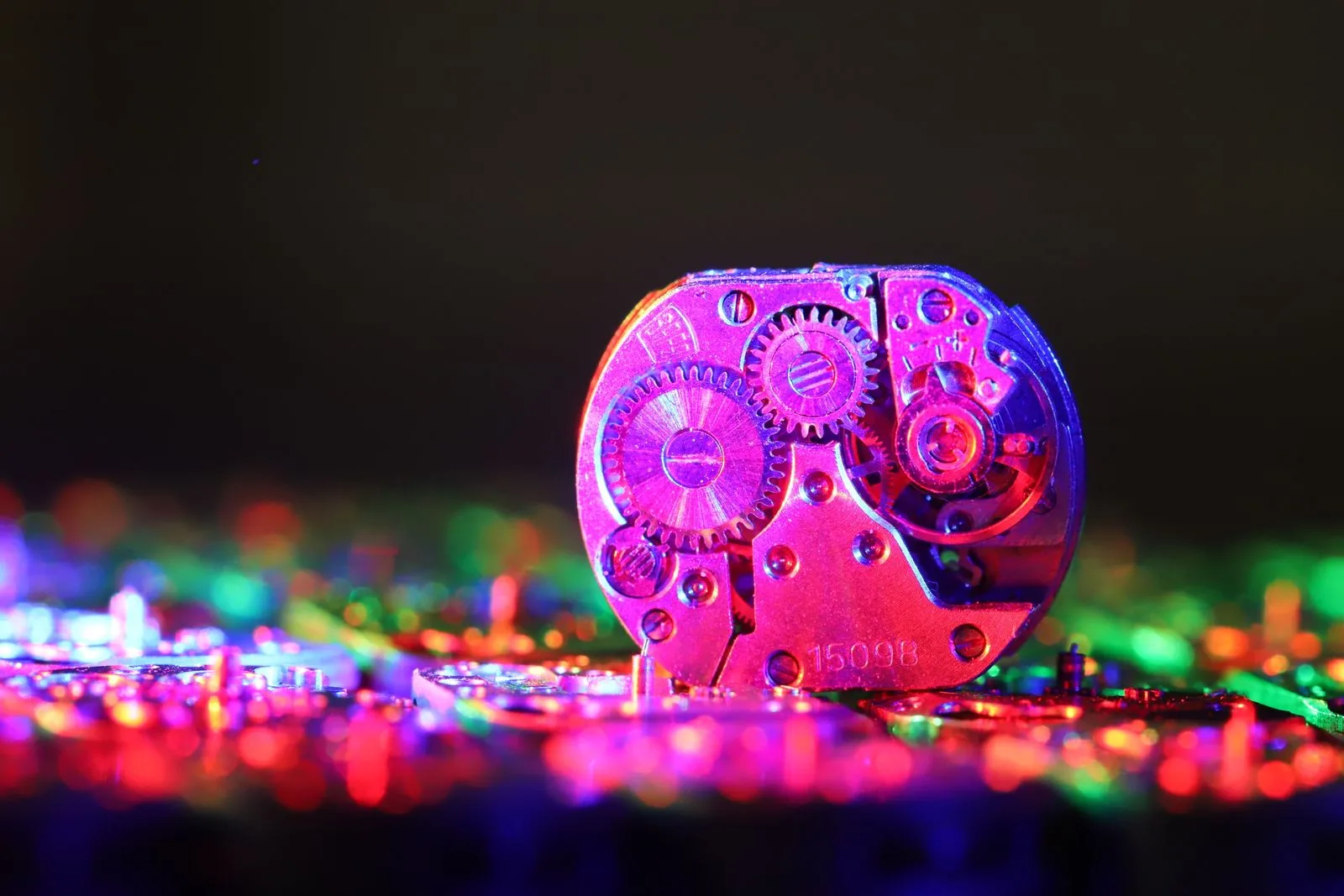 Loose watch movement on a dark surface among small parts; this watch storage guide covers the damp and magnets to avoid