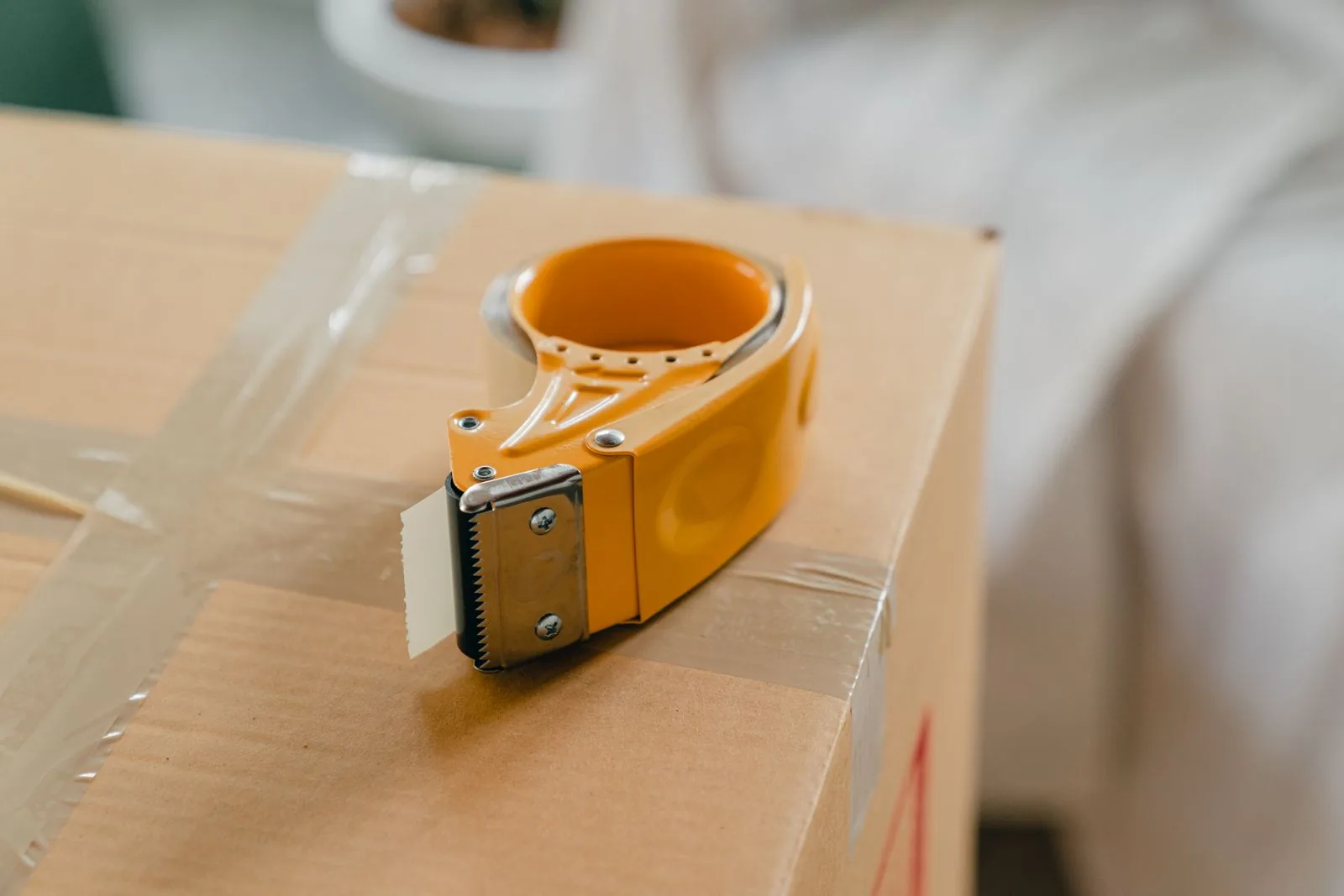 Tape dispenser on a taped cardboard parcel, the delivery step when buying on Watchfinder vs Chrono24