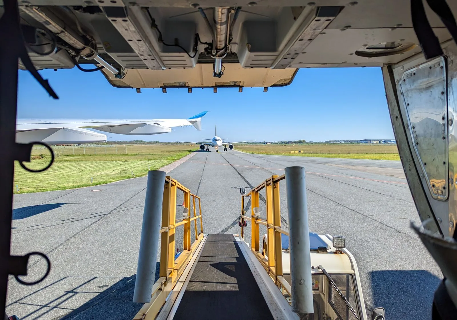 View through an aircraft cargo door onto the apron, as watches bought on Watchfinder vs Chrono24 may ship from abroad