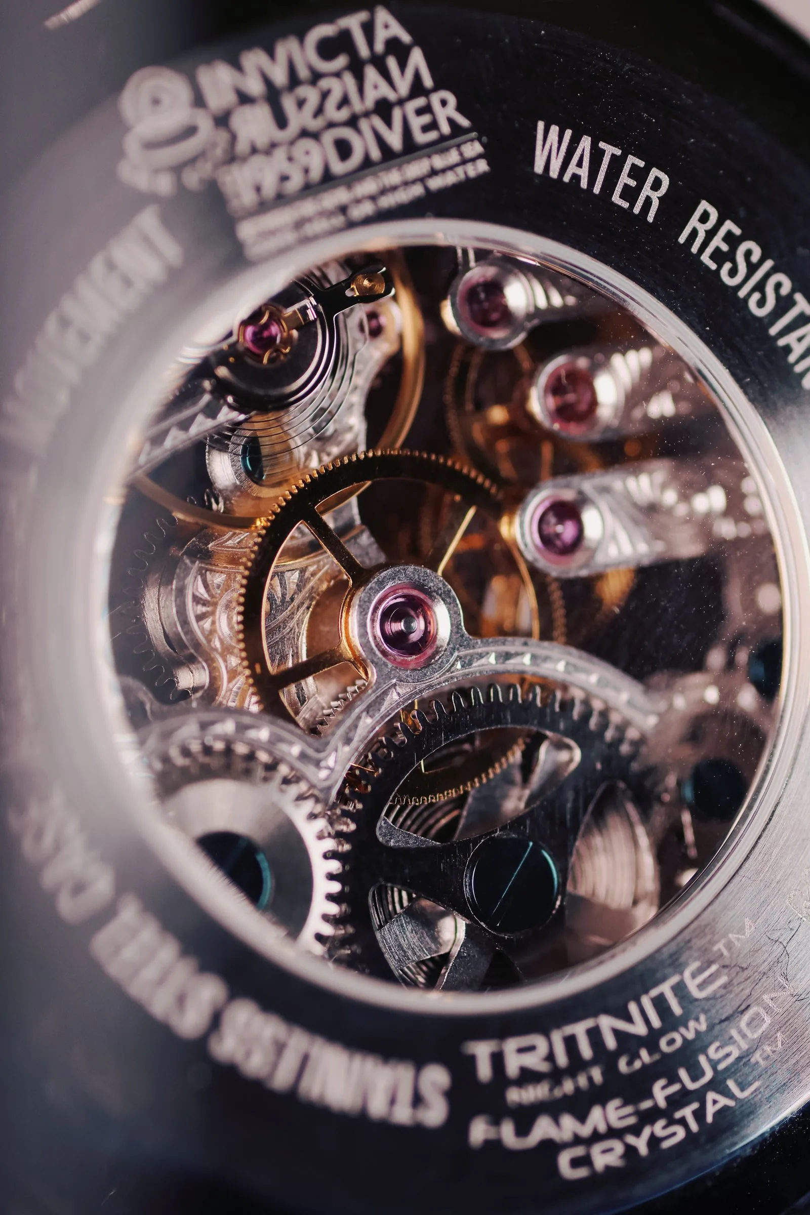 Macro of skeletonised watch gears and balance, the kind of movement tested under COSC certification